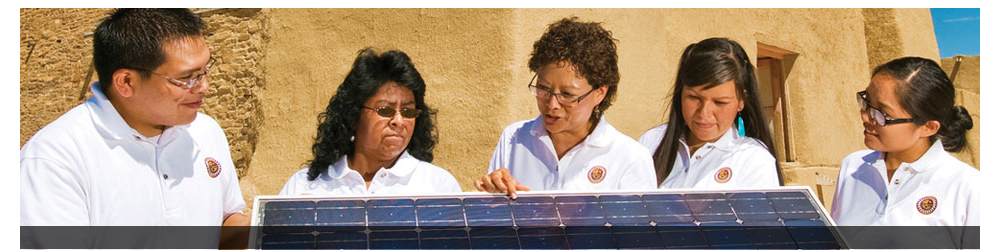Five people holding a solar panel