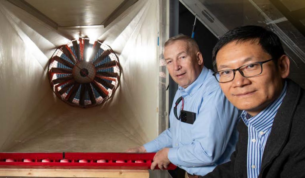 Johann Steinlechner of Muhlala and Professor Fangjun Shu position the Muhlala wind turbine model in the NMSU wind tunnel facility for testing.