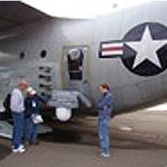 3 individuals standing outside of a large aircraft