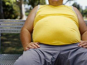 mid section view of a man sitting on a bench in a park --- Image by © Royalty-Free/Corbis