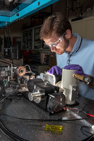 Optical engineer sets up equipment