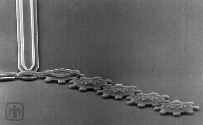 One of the first gear chains fabricated at Sandia, consisting of five gears in a linear arrangement.