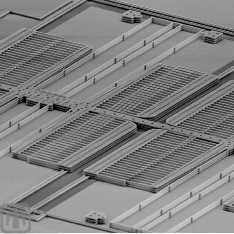 Although fabricated in the 5-layer process, the resulting structures are not far off the wafer substrate. Powerful magnification is necessary to see these comb drives and springs.