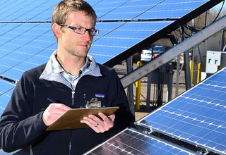 Researcher observing solar panels
