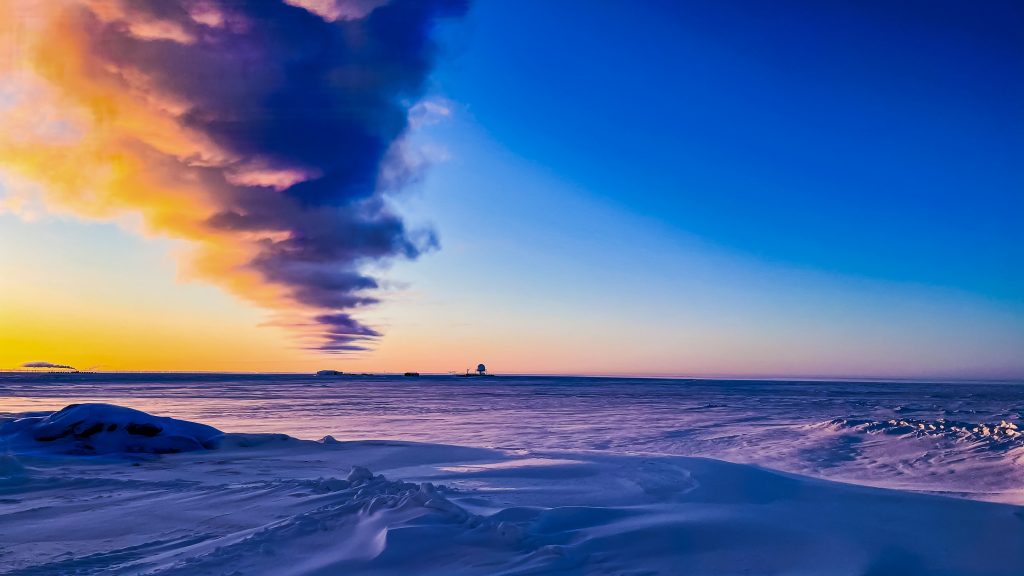 A snowy horizon with a research base sits in the Arctic where permafrost research is happening.
