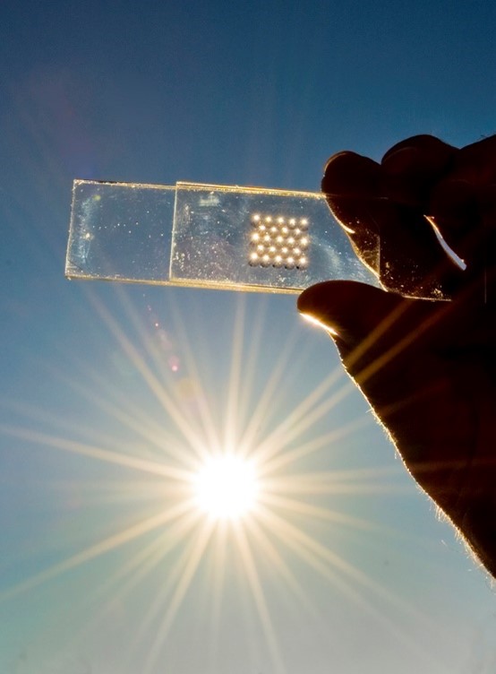 Researcher holding component against the sun