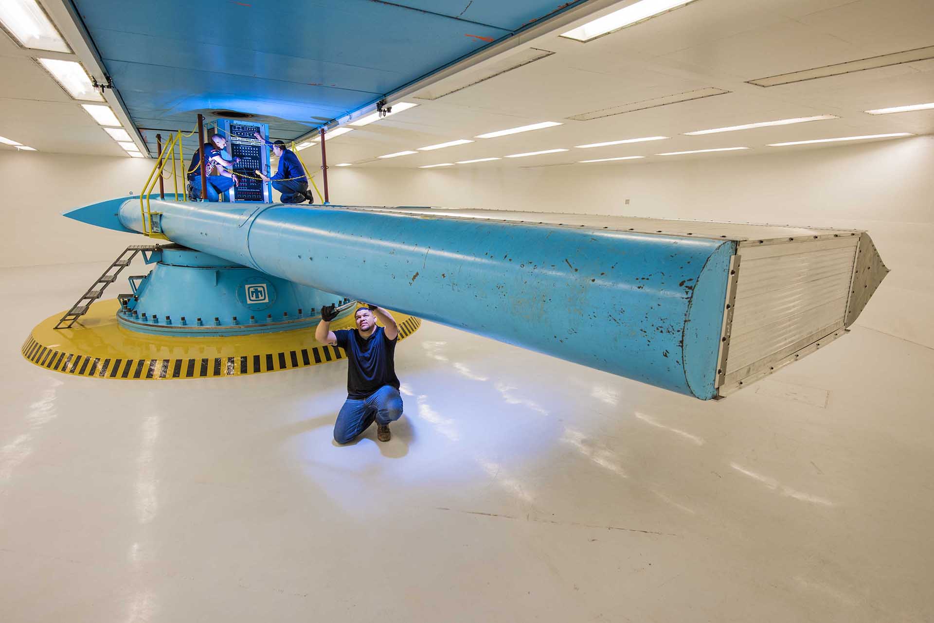 A mechanic works on a flight simulator.