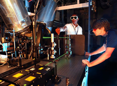 Two scientists working with laser beams