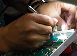 Researcher working on a component