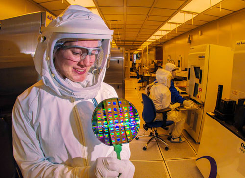 Researcher proudly displaying microsystem