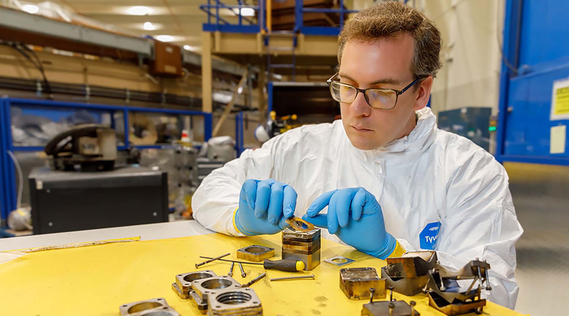 A Sandia physicist loads sample coatings into holders to test in Sandia’s Z machine.