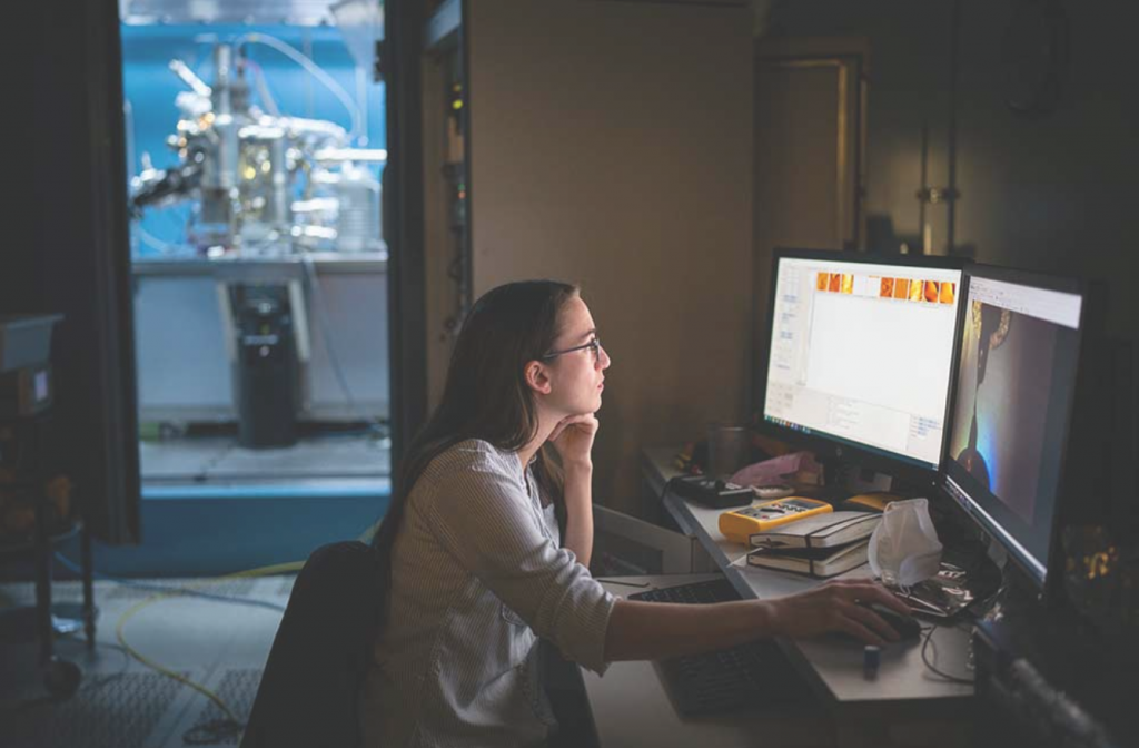 Postdoctoral researcher Caitlin McCowan inspects pieces of silicon at the atomic level. She uses a scanning tunneling microscope to spot imperfections as part of a quantum research project at Sandia. (Photo by Craig Fritz)