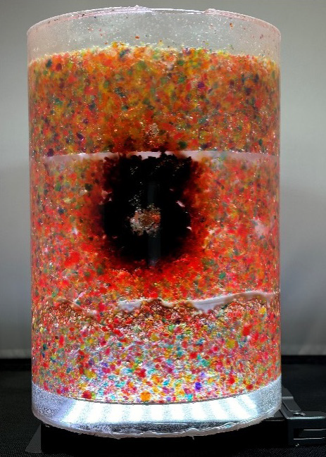 A container protected with Sandia's "Bleeding Materials & Enclosures" product indicates a tamper attempt. In this image, silicone is used to encapsulate the air-sensitive beads.