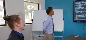 Project principal investigator Matthew Whitlock (left) and team member Hemanth Kolla (right) evaluate code for the Fenix framework.