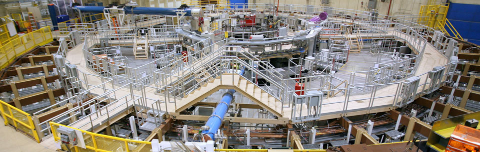 Z machine scientist examines one of the aluminum cylinders used in the Z pulsed power experiments. The monitor on the X-ray machine in the background displays a highly magnified, pre-experiment view of the wavering edges machined into the outside edge of the cylinder. These were used to intentionally start the growth of the instability. Read more: bit.ly/2YVSbSv