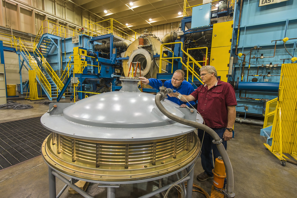 Pat Lake (left) and Ray Thomas examine the vacuum test fixture for the High-Energy Radiation Megavolt Electron Source, or HERMES III, insulator stack. HERMES III recently successfully fired its 10,000th shot at Sandia Labs. Read more atbit.ly/2z2WxIM. Photo by Randy Montoya.