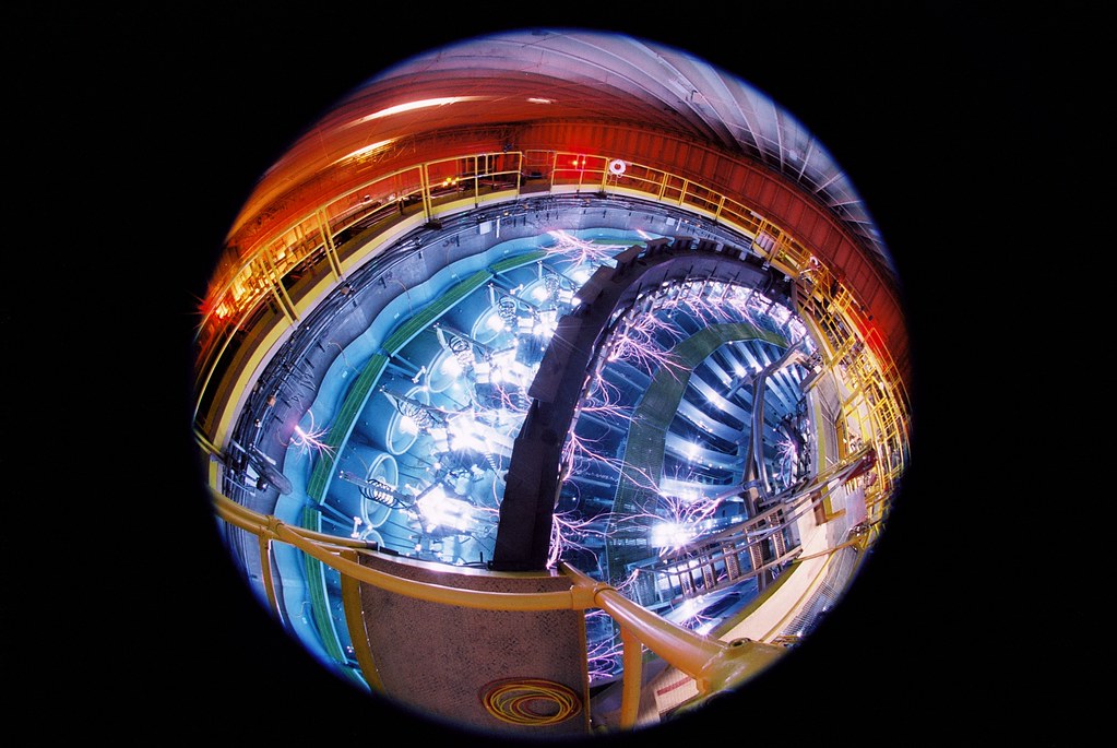 Saturn, one of Sandia's pulsed-power machines, delivers hard radiation during one of its milestone shots. The scarcity of jagged, lightning-like arcing between different water/metal interfaces means that the machine's water insulation is effective and that relatively much of its electrical pulse is traveling on its intended path from the machine's circular exterior to its central target. Learn more atbit.ly/31i8RBg. (Photo by Randy Montoya.)