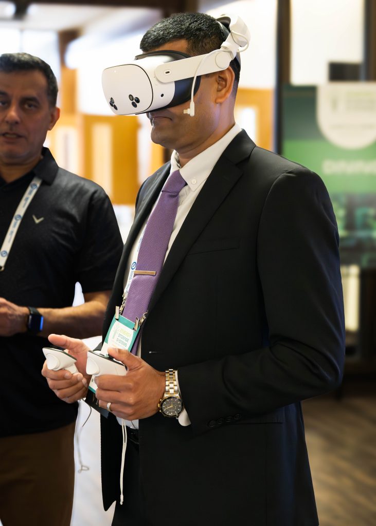Mohamed Kamaludeen, technical program manager at the DOE Office of Electricity, participates in an XR demonstration designed to help fire fighters practice their response to emergencies involving battery systems. / Credit: Alicia Bustillos, Sandia National Laboratories