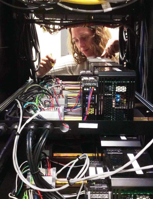 Chantel Nowlen inspects rod control rack power supplies.