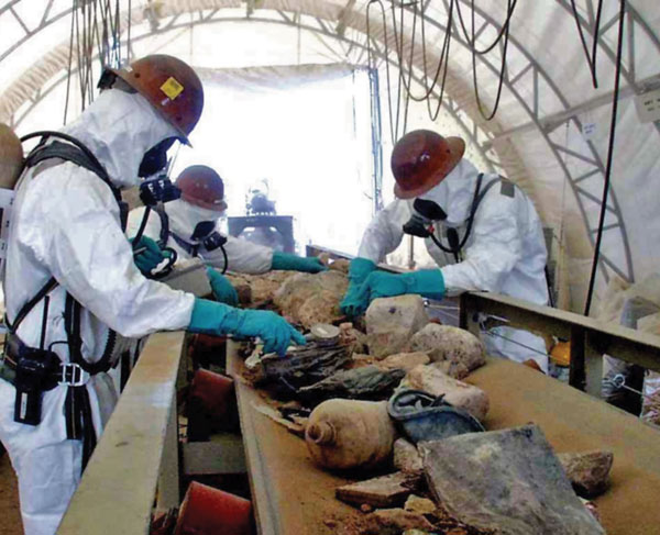 Technicians sort waste excavated from Sandia’s chemical waste landfill