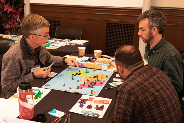 workshop participants play board game