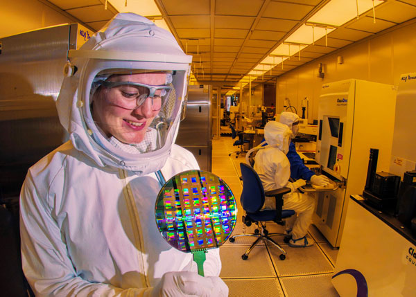 scientist holds silicon wafer