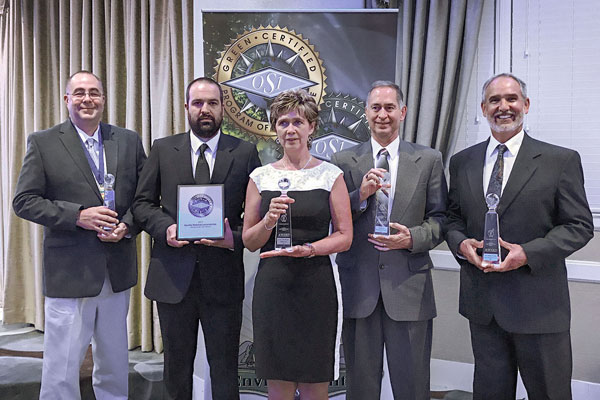 custodial service representatives pose at award ceremony