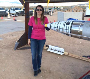 team member checks shorting pins on B61 rocket sled test