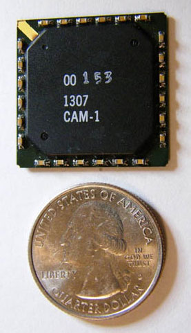 Packaged Group 1 CAM ASIC with quarter for scale