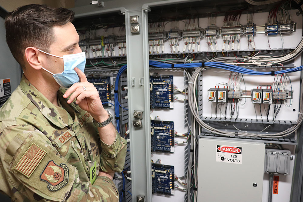 A Kirtland Air Force Base airman observes security system upgrades.