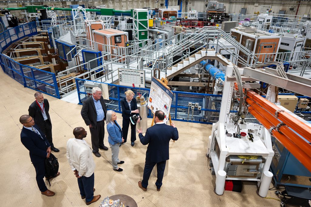 NNSA and Sandia leaders listen to a presentation by the director of Z machine during a recent tour of the facility.