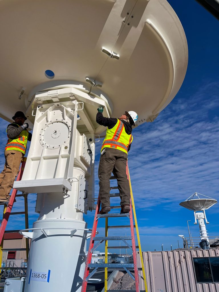 Mechanical utility pipefitters fabricating a pipe spool piece.