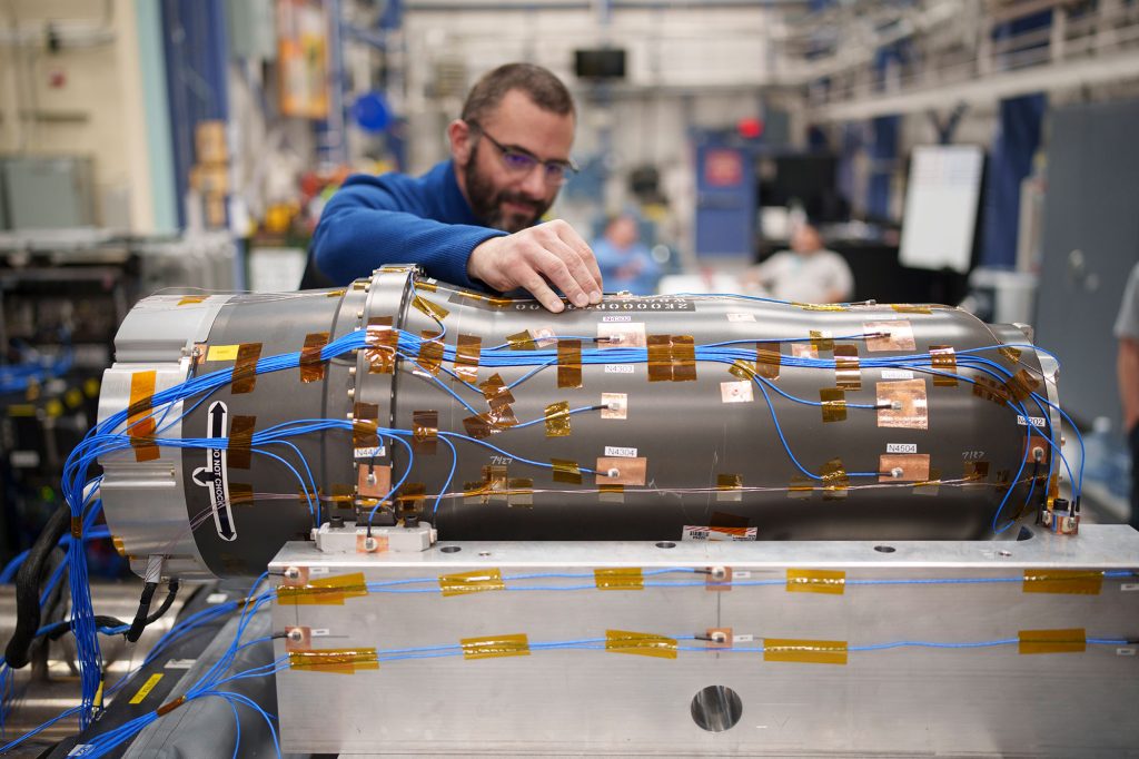 An engineer prepares an inert W80-4 for shaker table testing.