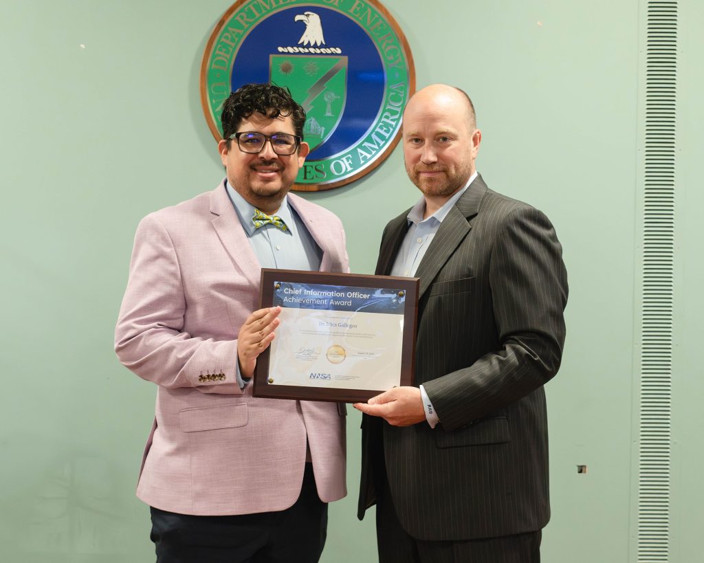 Cybersecurity researcher Irbis Gallegos, left, accepts an award from NNSA Chief Information Officer Jamie Wolff for his exceptional work. (Photo courtesy of NNSA)