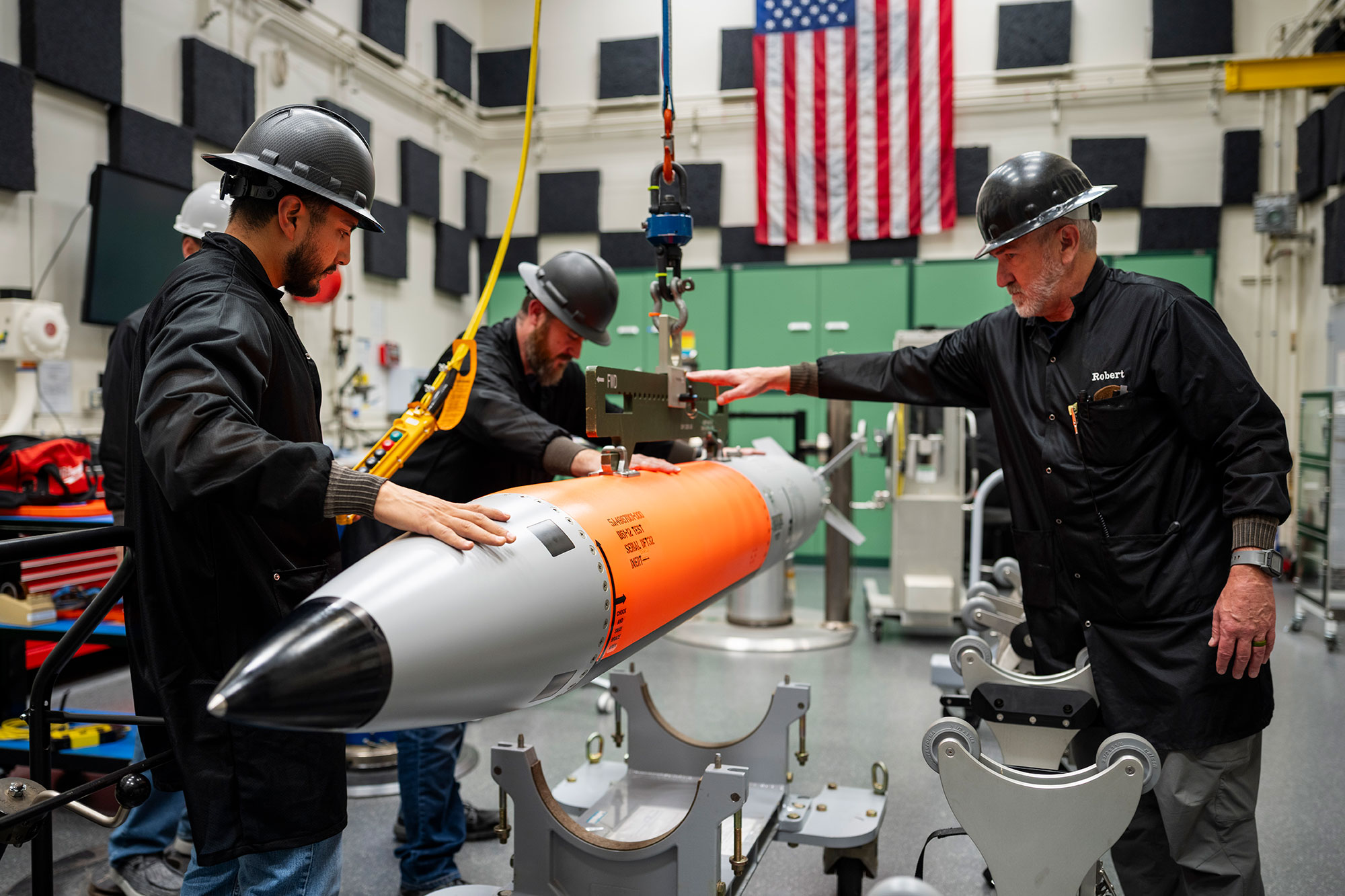 Nuclear deterrence team members weigh the first B61-13 HiFi unit.