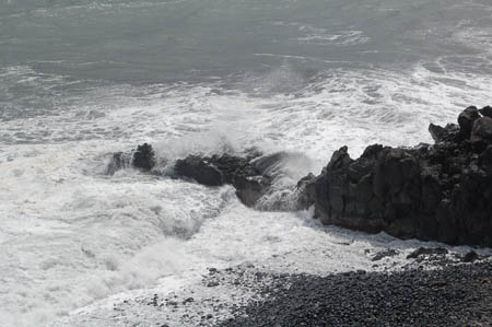waves crashing into rocky shoreline