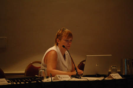 Female participant sitting at a table during conference