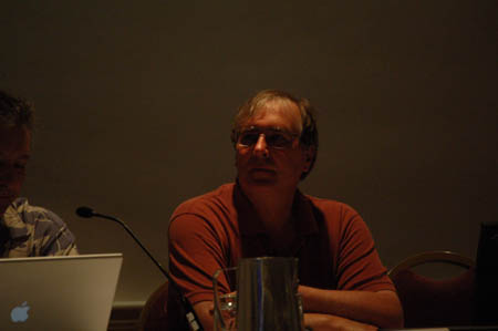Male Participant sitting at a table during conference