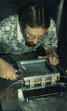 Don Fox inspects the fracture test cell prior to running an experiment.