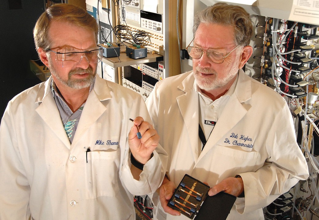 Two scientists examining hydrogen monitoring sensor