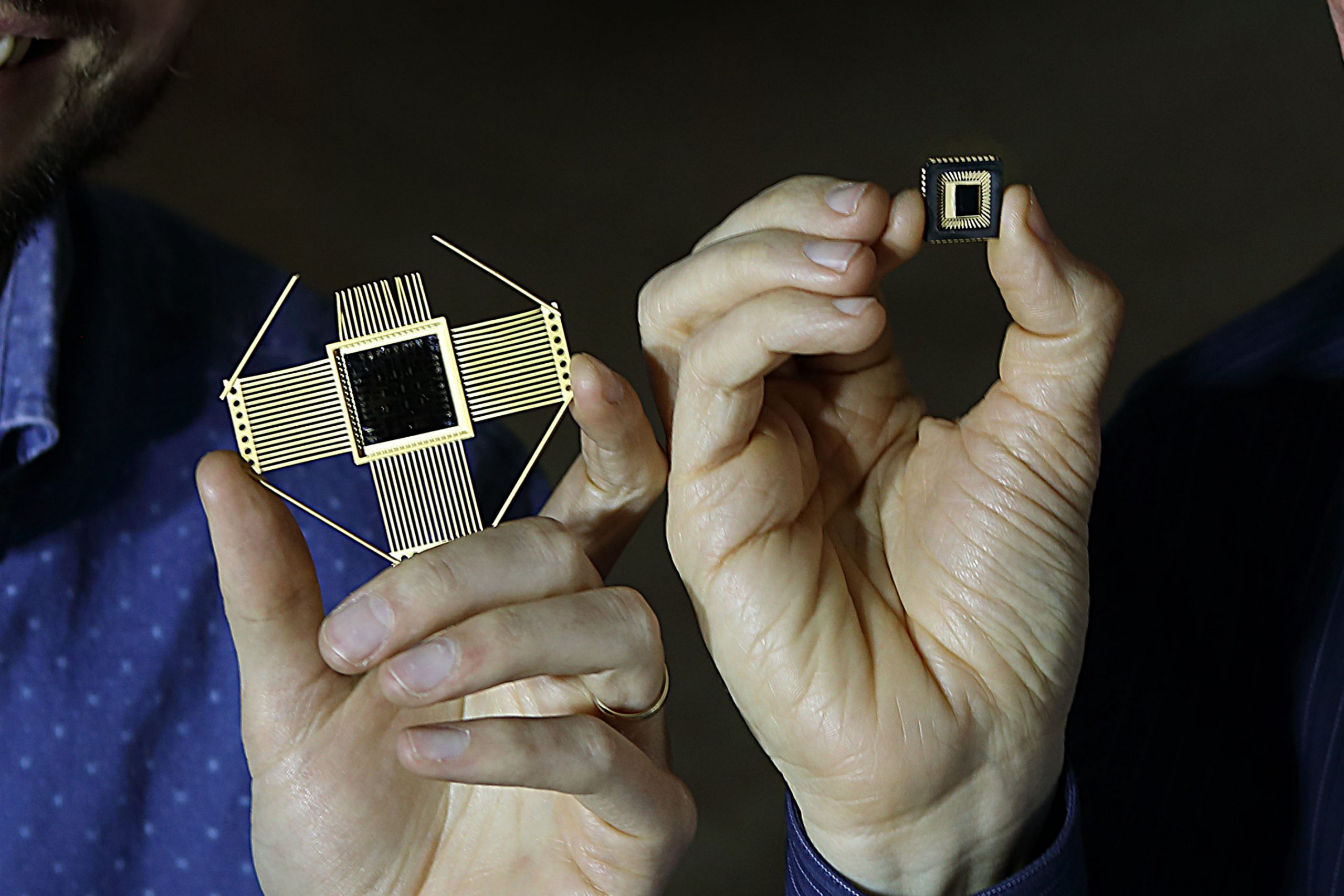 Men holding neuromorphic silicon wafers