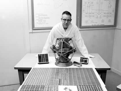 Sandia Vela-team member Robert House displays the modules that held the logic systems of the Vela satellites, 1963