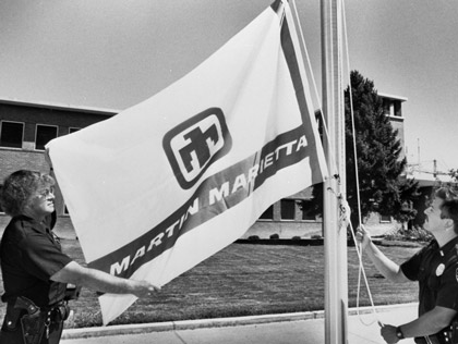 Sandia Security officers Louis Mathews and Jeff McCullough raised the Martin Marietta flag at Sandia's main entrance in New Mexico