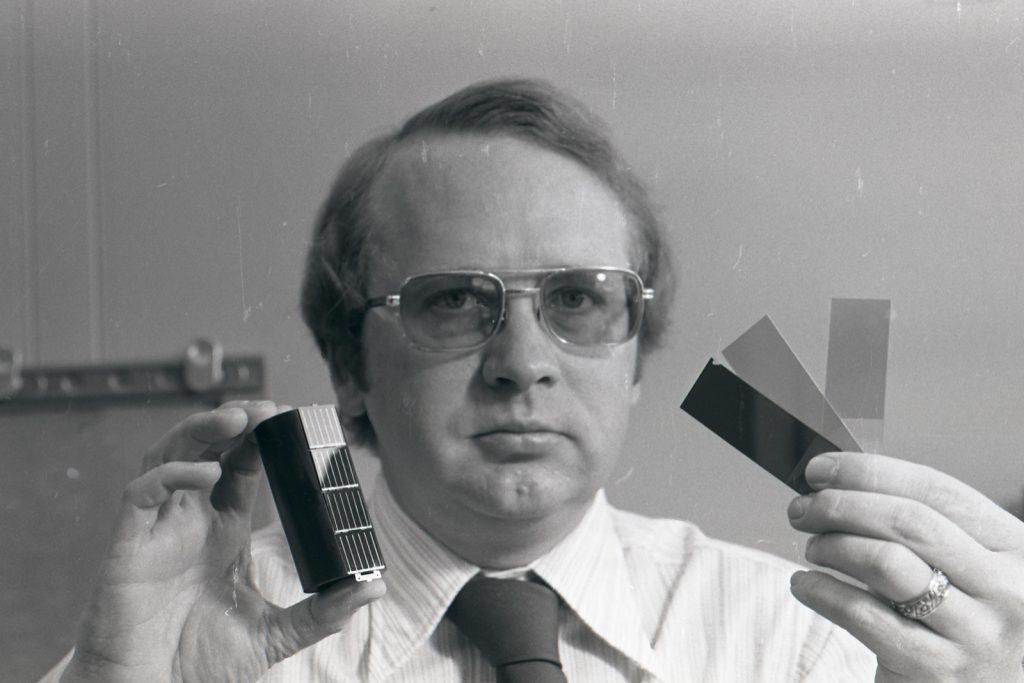 Don Schueler with a deck of four solar cells (left) and samples of thin films Sandia was investigating to replace silicon in the cells