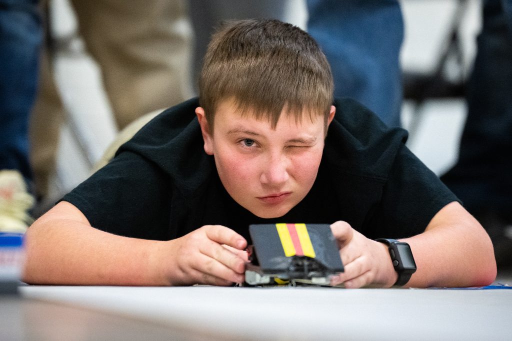 Chance Bonham, 12, from the Berrendo Middle School launches his team’s electric car drug the New Mexico Electric Car Challenge sponsored by Sandia and Los Alamos National labs at Van Buren Middle school in Albuquerque on Saturday Nov. 19, 2022. Photo by Craig Fritz/Sandia National Labs