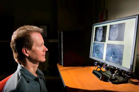 Sandia Researcher Mike Haass demonstrates how an eye tracker under a computer  monitor is calibrated to capture his eye movements on the screen.