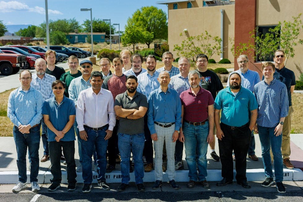 Team members from Sandia, Los Alamos, and Lawrence Livermore National Laboratories stand in front of Sandia's Computing Science and Research Institute.