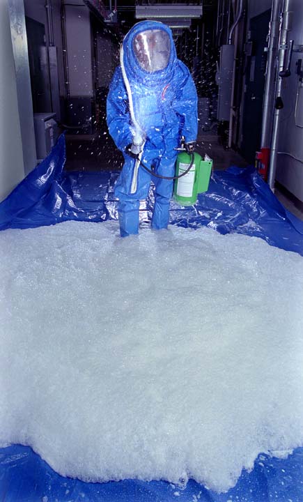 Image of Sandia Decon Formulation co-developer Maher Tadros demonstrates application of the formulation from a pressurized canister. The foam could be sprayed from handheld canisters or from trucks, or it could be incorporated into high-profile government military buildings. The formulation is non-toxic. Protective clothing is required to protect decontamination personnel from chemical and biological agents.