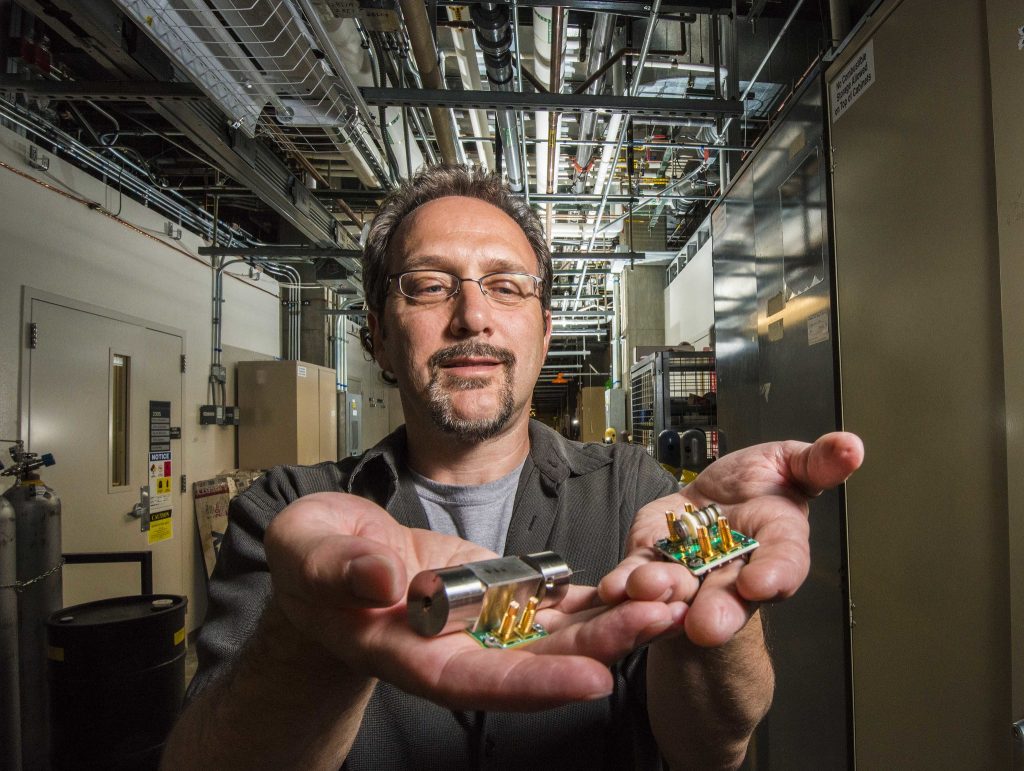 Sandia Labs researcher Ron Manginell displays new miniature pulsed-discharge ionization detectors, or mini-PDIDs, he is developing along with Sandia colleagues. The tiny detectors have broadened the scope of chemical targets for Sandia’s microanalytical detection technology to toxic industrial chemicals, biological volatiles, greenhouse gases and more.     Photo by Randy Montoya.