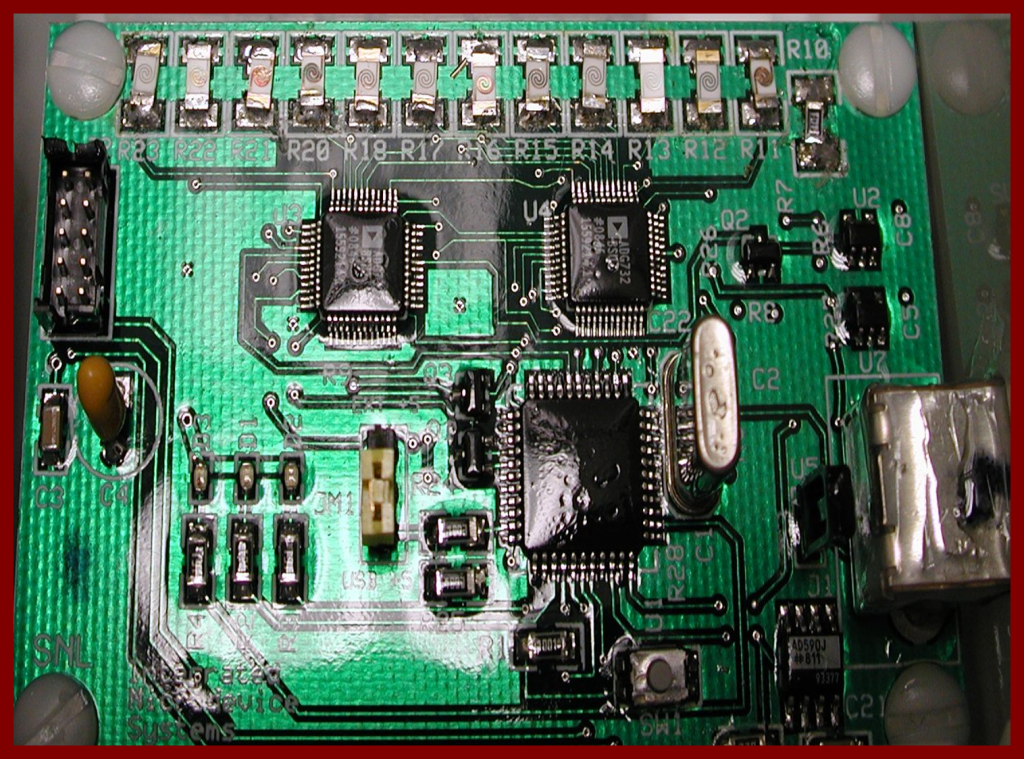 A line of corrosion sensors of various widths and thicknesses soldered to a PC board.